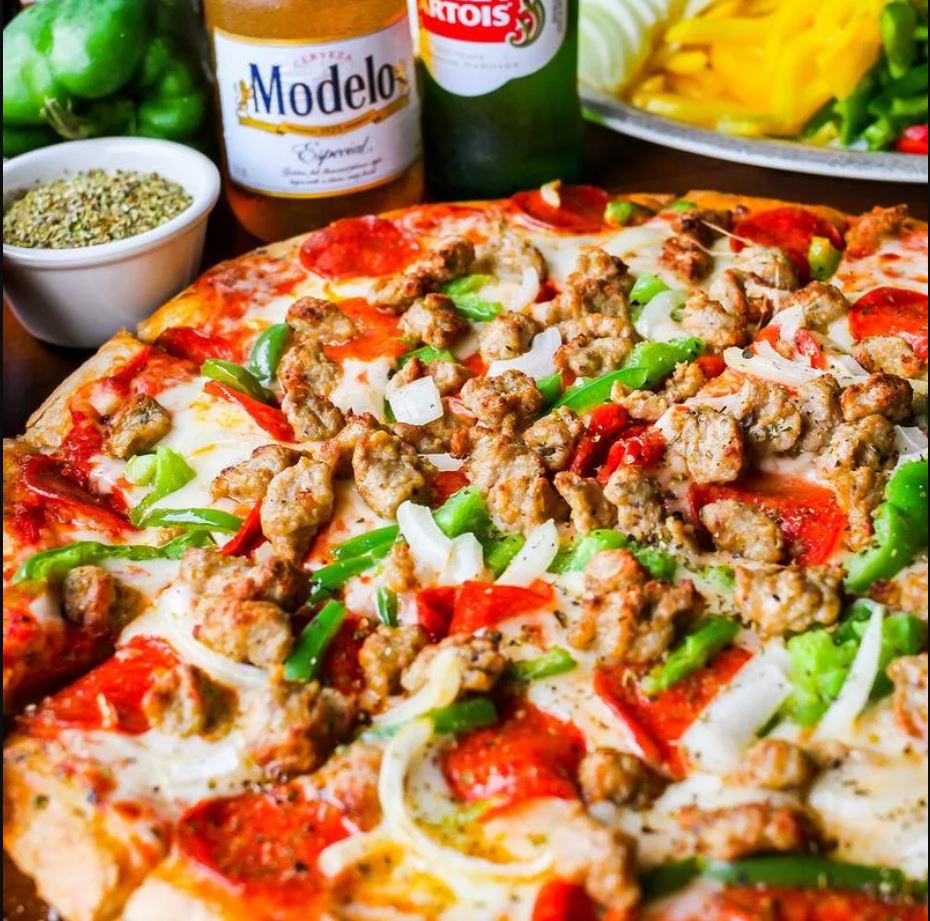 A New York-style pizza with sausage, pepperoni, peppers and onions